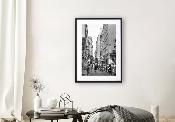 Black and white photograph of narrow street in Paris, France