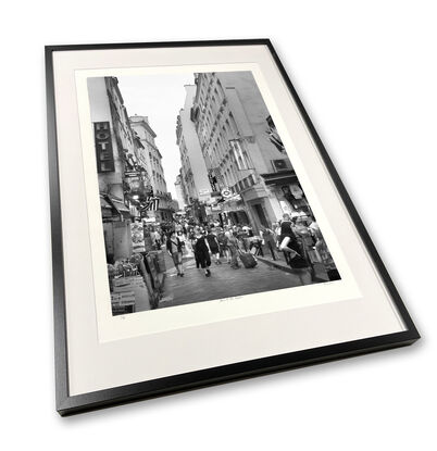 Black and white photograph of narrow street in Paris, France