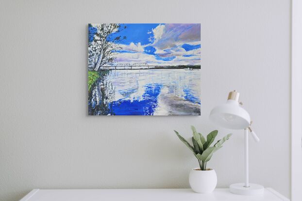 Landscape painting of the Murray River. There are white clouds in the sky which are reflecting in the royal blue water. The painting is mostly royal blue and white. There is a riverbank to the left side with a gum tree overhanging the water. The trees reflections are in the water. A small boat can be seen in the distance.