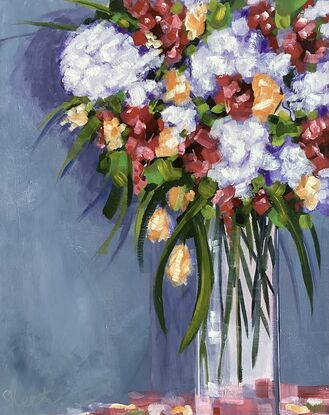 A bouquet of flowers in a tall glass Vase,  A blue grey wall with soft shadows.