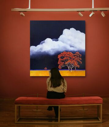 Large square Australian landscape with dark blue sky with huge white fluffy clouds and gold orange foreground with bright red and orange trees in the foreground,  Lucinda Leveille, original artwork, statement