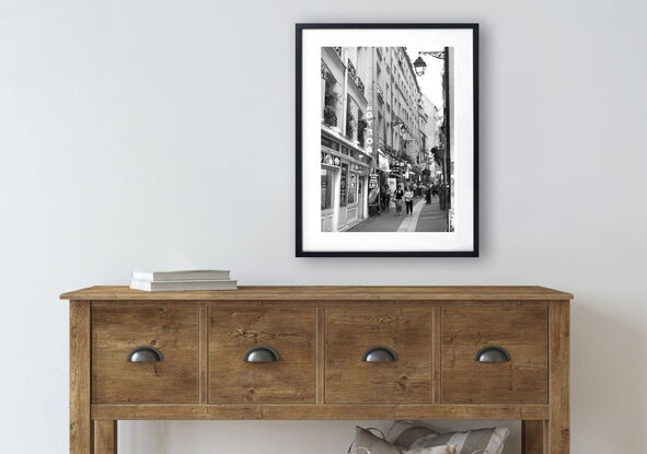 Black and white photograph of narrow street in Paris, France