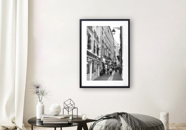 Black and white photograph of narrow street in Paris, France