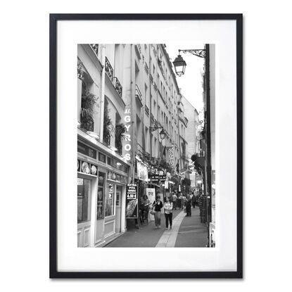 Black and white photograph of narrow street in Paris, France