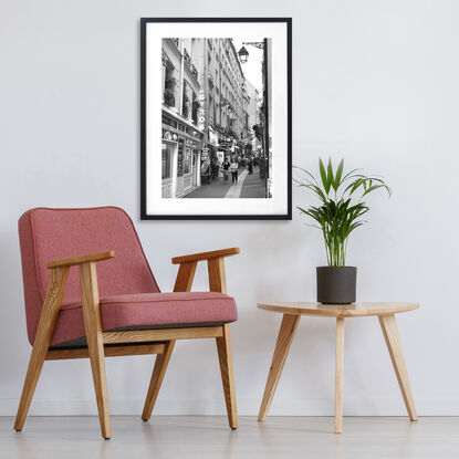 Black and white photograph of narrow street in Paris, France