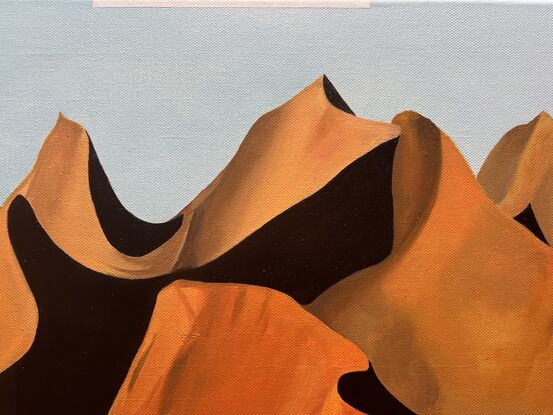 Tall and bright sand dunes. Shadows. Bold forms under light blue sky.