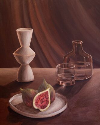 A side lit table scene with long shadows & a beam of light. A plate with figs in the foreground with a white modern vase, glass bottle and drinking glass with water in it.