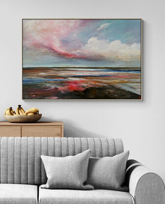 Colourful Textured landscape with fluffy vibrant hot pink, white and blue fluffy clouds above a sunset filled landscape with blue water flowing through.