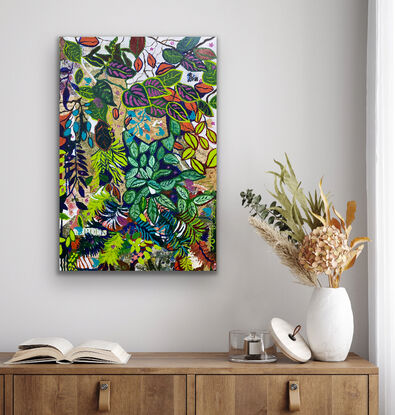 A mixture of brightly coloured leaves from orange and deep green with pink splashes, this is a jungle of leaves growing and climbing in harmony across the canvas. Painted areas and printed botanical pieces that pop through in a harmony the painting continues around the sides so no frame is required. 