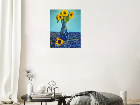 Golden yellow sunflowers in blue glass vase kept on a patterned table cloth   