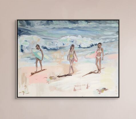 Three women walk along beach.