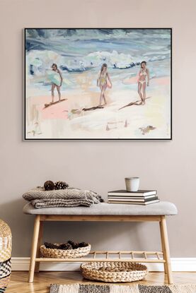 Three women walk along beach.