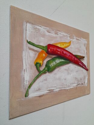 Long green, red and yellow chilies placed on white background 