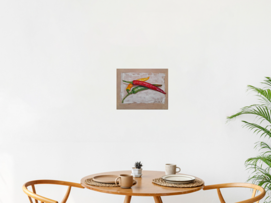 Long green, red and yellow chilies placed on white background 