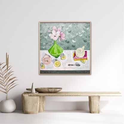 Various domestic objects scattered around within the composition. Magnolia flowers in a green glass vase with cut grapefruit scattered in the foreground.  A teapot on some books and tea cup waiting for tea to be poured.  