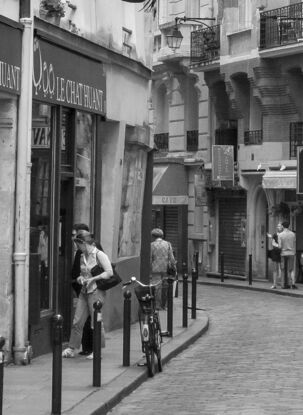 Black and white photograph of wedding couple dancing in street, Paris, France