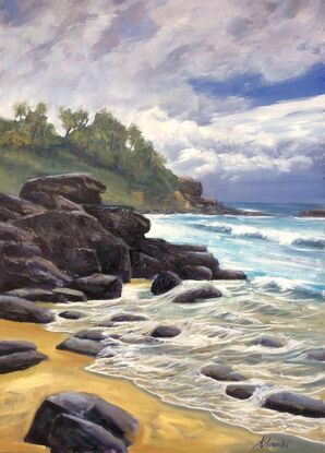 Flowing waves rushing over shallow rocks at the far end of Main Beach Yamba.  You can see the far headland and in front of them is a rocky outcrop.  It is a cloudy day but there is also a hint of sunlight in the sky.