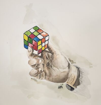 A hand holding a rubik's cube.