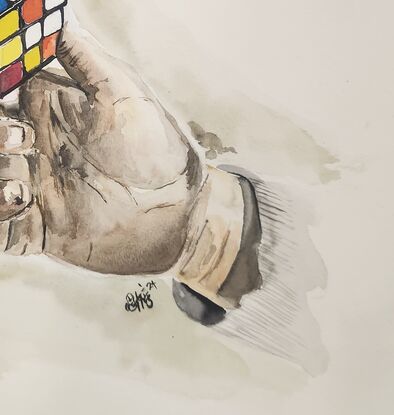 A hand holding a rubik's cube.