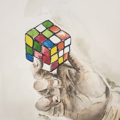 A hand holding a rubik's cube.