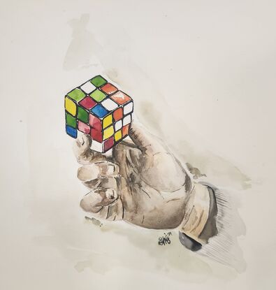 A hand holding a rubik's cube.