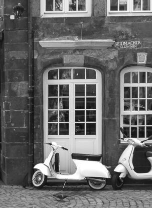 Black and white photograph of narrow street in Paris, France