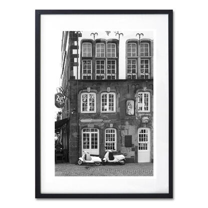 Black and white photograph of narrow street in Paris, France