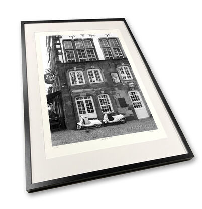 Black and white photograph of narrow street in Paris, France