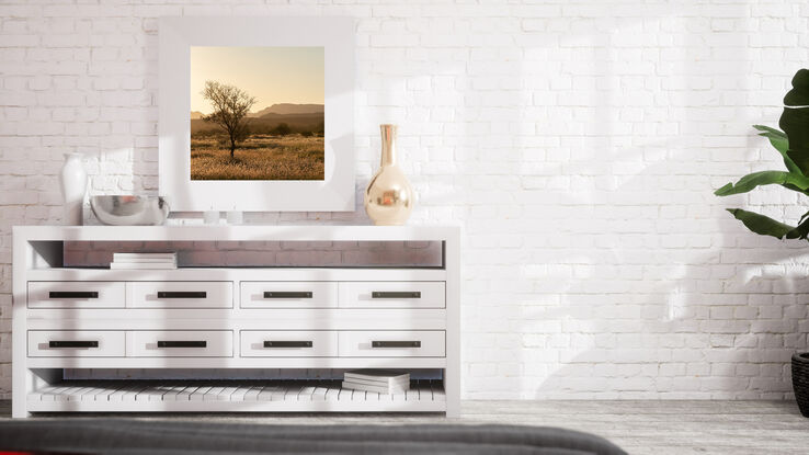 "Outback" photograph showcases rugged Australian wilderness with clay-like landscape and striking light and shadow play. Earthy terracotta tones dominate color palette for a captivating image.