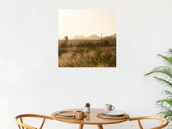 "Outback" photograph showcases rugged Australian wilderness with clay-like landscape and striking light and shadow play. Earthy terracotta tones dominate color palette for a captivating image.