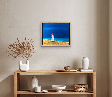 A woman in a red hat looks out to sea.