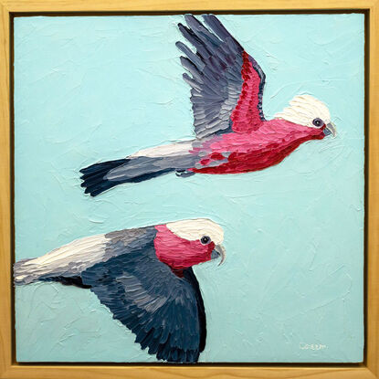 A textured oil painting of two pink galahs flying across the blue sky.