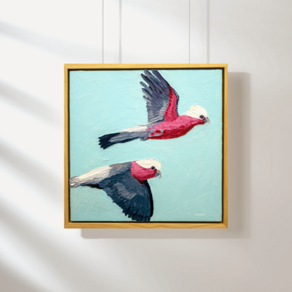 A textured oil painting of two pink galahs flying across the blue sky.