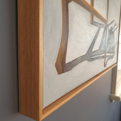 A timber chair with strong shadow.   Framed in Tasmanian Oak. 