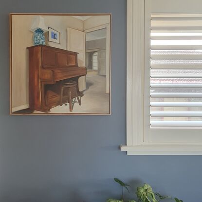 Piano and chair with view through to other rooms. Framed in Tasmanian Oak. 