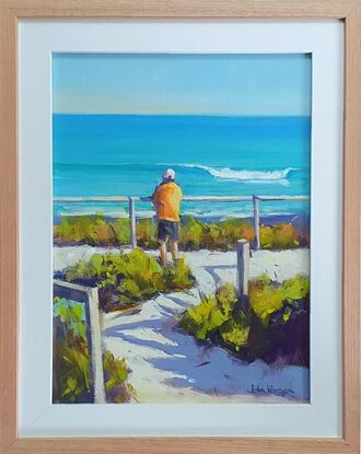 A figure stands overlooking a summer beach and feels good about life