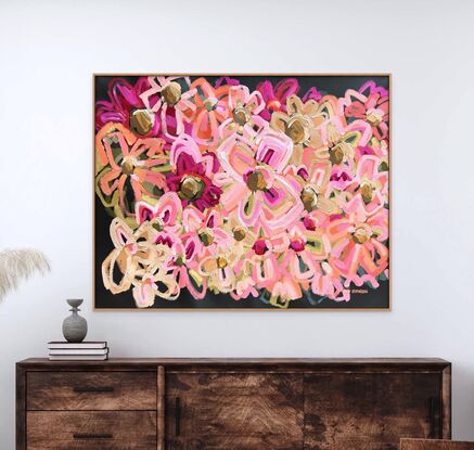 An abstract floral artist quality print in pink, earthy and green tones with a warm charcoal coloured background and timber frame.