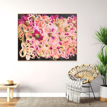 An abstract floral artist quality print in pink, earthy and green tones with a warm charcoal coloured background and timber frame.