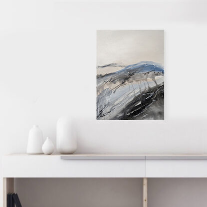 A large abstract landscape of the Victorian Alpine region in mixed media in pale blue, cream, beige and grey.