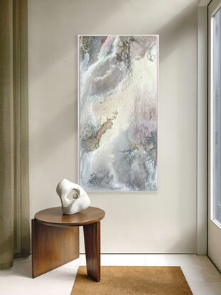 This artwork features an abstract composition with a mix of muted tones, predominantly soft grays, whites, and subtle hints of pink and mauve. There are patches of gold leaf that add a touch of metallic texture and depth to the piece. The overall effect is reminiscent of a dreamy, ethereal landscape, possibly evoking the feel of swirling clouds or a misty, mountainous terrain. 

