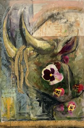 Bull figure kneeling down in among pansies and flowers