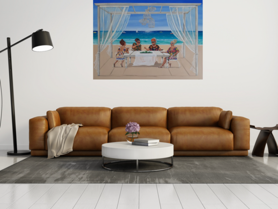 Four women sitting at a table by the beach