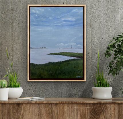 A view of the marshland, grass,  water and sky at the Waterfront Park in Charleston, South Carolina, USA.