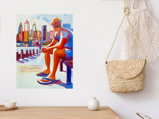 "Cityscape Contemplation" by Christine Beard captures a serene moment of reflection as a figure gazes upon a vibrant city skyline. The watercolor painting is rich with warm hues that bring the urban landscape to life, highlighting the architectural beauty and dynamic energy of the city. The figure, seated thoughtfully, contrasts with the bustling background, creating a striking juxtaposition between personal stillness and the ever-moving city. This artwork is a perfect representation of modern life, where moments of solitude are found amidst the urban hustle. Ideal for those who appreciate the intersection of contemporary cityscapes and contemplative art.





