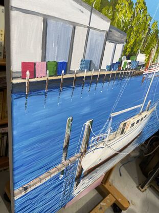 Sunny winter day, depicting a yacht, and its reflections in the foreground and trawlers and wharves in the back ground.