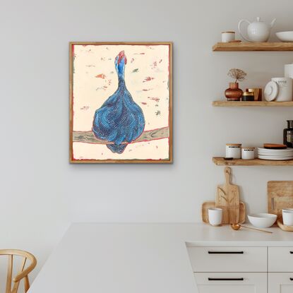 Guinea fowl with head raised and mouth open perched on a large stick with a cream background.