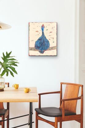 Guinea fowl with head raised and mouth open perched on a large stick with a cream background.