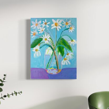 Garden daisy’s in glass vase with blue  background. Relaxing and peaceful scene 