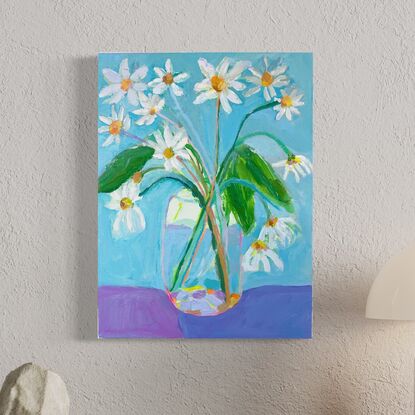 Garden daisy’s in glass vase with blue  background. Relaxing and peaceful scene 