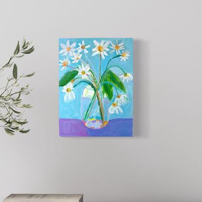 Garden daisy’s in glass vase with blue  background. Relaxing and peaceful scene 